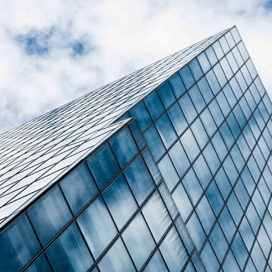 upward angled photo of skyscraper and blue sky
